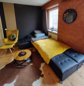 a bedroom with a bed and a couch and a table at Downtown/Balcony/Coffee Bar/TV-Streaming/top WLAN in Bielefeld