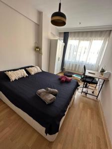 a bedroom with a large bed and a desk at kadıköy rıhtımda özel odalar in Istanbul