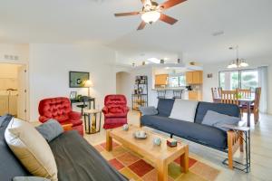 a living room with a blue couch and red chairs at Patio, Views and Boat Parking Lake Havasu Home! in Lake Havasu City