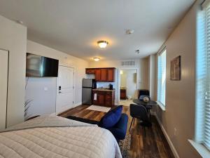 a bedroom with a bed and a living room at Cozy Stay at the Inman - 214 in Champaign