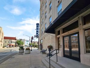 a sidewalk in a city with a building and a street at Cozy Stay at the Inman - 214 in Champaign