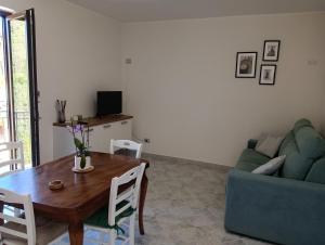 a living room with a table and a couch at Lux Domus in Montoro Inferiore