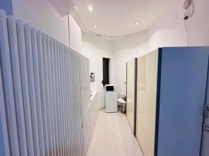 a hallway of a bathroom with a toilet at Riviera Studios in Mamaia