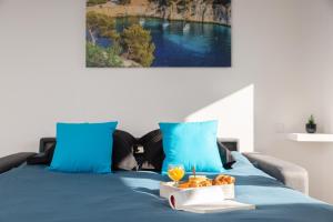 a blue bed with a tray of fruit on it at Sweet Calanque - Host Provence in Cassis
