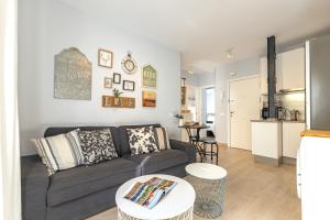 a living room with a couch and a table at Charming 2 Bedroom Apartment at Rodrigo de Triana By Oui Seville in Seville