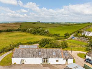 an aerial view of a white barn in a field at The Haybarn in Dundrennan