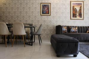 - un salon avec un canapé, une table et des chaises dans l'établissement Vacation Villa, à Lahore