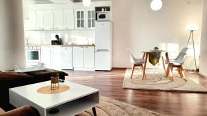a kitchen and a living room with a table and chairs at Velvet Vista in Štip