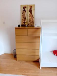 a bedroom with a dresser with two vases on it at 2 Bed Mill Hill Flat in Mill Hill