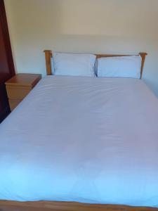 a white bed with a blue light on it at 2 Bed Mill Hill Flat in Mill Hill