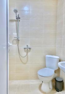 a bathroom with a shower with a toilet and a sink at Hello Studios Budget Stays Free Parking & Wifi in Stara Zagora +121 photos