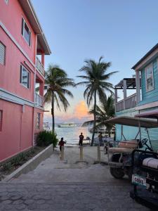 a group of people standing on a beach with palm trees at La Casa de Paz Hotel in San Pedro