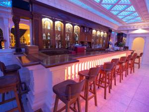 a bar with a row of chairs in a building at Parthenon in Ios Chora