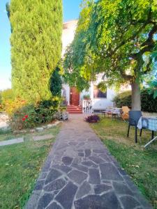 a stone walkway in front of a house at La Magnolia - Fano in Fano