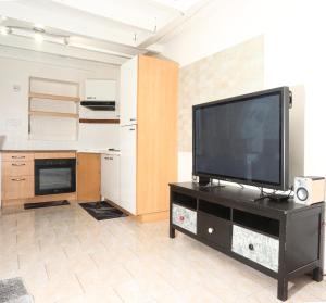 a living room with a flat screen tv on a entertainment center at Maison hyper centre Romilly-sur-Seine in Romilly-sur-Seine