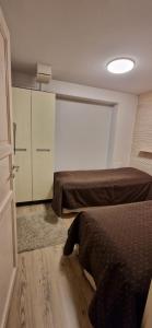 a bedroom with two beds and a closet and a door at Levin Kolmio C4 in Kittilä