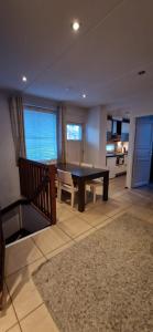 a dining room with a table and chairs and a kitchen at Levin Kolmio C4 in Levi +7 photos
