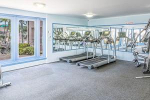 a gym with several treadmills and ellipticals at Caribbean Palm Village Resort in Palm-Eagle Beach