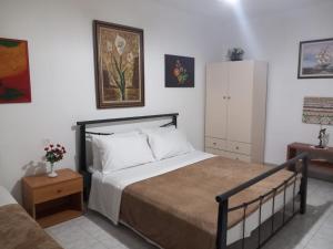 a bedroom with a bed and a dresser and a bed sidx sidx sidx sidx at Vila Gjoka in Himare