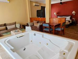 a large bath tub in a room with a living room at Seven Crown La Paz Centro Historico in La Paz