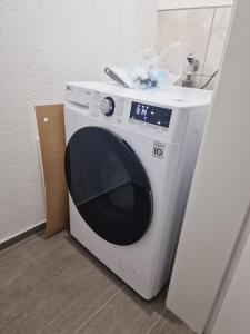 a white washing machine sitting next to a door at Zweibettzimmer 2 in Zweibrücken