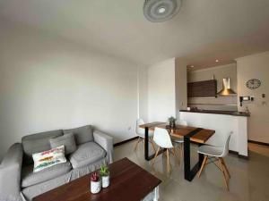 a living room with a couch and a table at Departamento para dos personas- Barrio Camba Cua in Corrientes