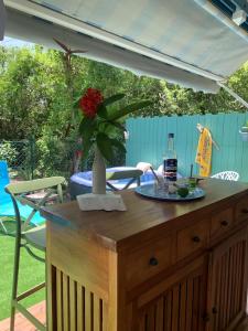 a table with a plate of food and a bottle of alcohol at Un p'tit coin Zen in Saint-François