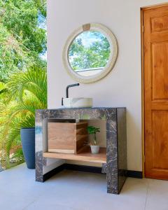 a bathroom with a sink and a mirror at LaLola Villa Privada in Cahuita