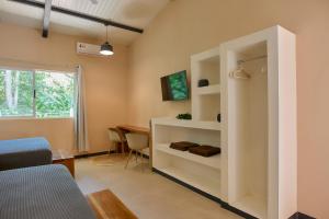 a living room with a white cabinet and a table at LaLola Villa Privada in Cahuita