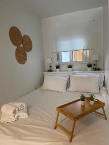 a large white bed with a coffee table in a room at Persephone Stay Inn in Eleusis