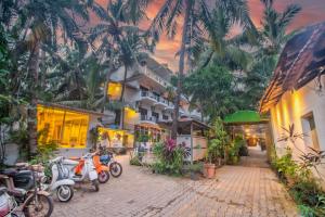 a group of motorcycles parked next to a building at GOA Down D Vilage Prime in Candolim