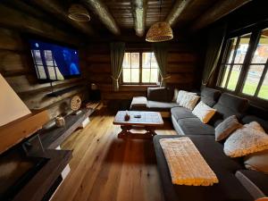 a living room with a couch and a table at Cabin House Čičmany- Relaxačné zariadenie s ubytovaním in Čičmany