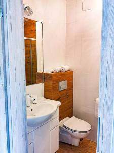 a white bathroom with a sink and a toilet at Apartament Hubertus in Bochnia