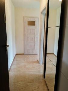 an empty room with a door and a wooden floor at Apartament Hubertus in Bochnia