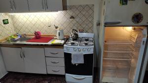 a kitchen with a stove and a sink and a refrigerator at Mundo Felix in Buenos Aires