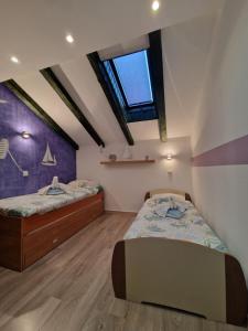 1 dormitorio con 2 camas y ventana en Apartments Marica, en Zadar