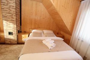 a bedroom with two beds in a attic at Котедж "Валерія" in Vorokhta +40 photos