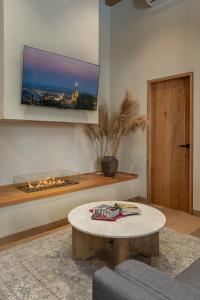 a living room with a tv and a coffee table at Le Cottage San Miguel de Allende, Modern Luxury in Centro with Pool & Jacuzzi in San Miguel de Allende +100 photos