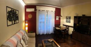 a living room with a couch and a table at Departamento Pocitos con anfitrión in Montevideo