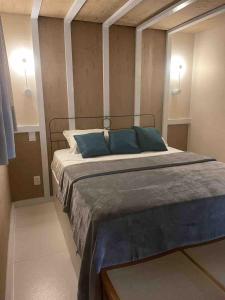 a bedroom with a large bed with blue pillows at Apartamentos dos Sonhos Bananeiras in Bananeiras +32 photos