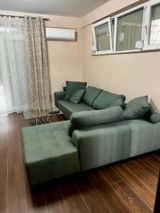 a green couch sitting in a living room at Juliya Apartment in Kavadarci