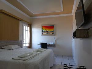 a bedroom with a bed with towels on it at Hotel Boulevard in Araripina