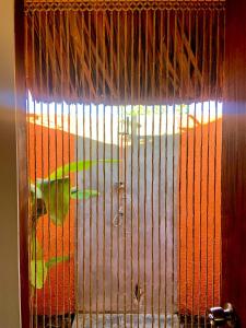 Una puerta con una jaula con un perro dentro. en Tropical Cabins Curaçao, en Dorp Sint Michiel