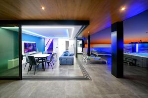 a dining room and living room with a table and chairs at Blue Star Meloneras Villa in San Bartolomé de Tirajana