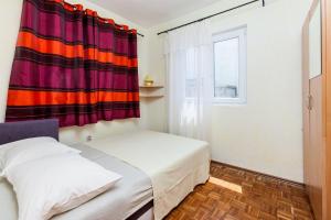 a bedroom with two beds and a window at House Ivana Tribunj in Tribunj +6 photos