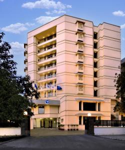 a large pink building with a lot of windows at Fortune Inn Haveli, Gandhinagar - Member ITC's Hotel Group in Gandhinagar