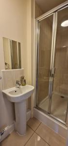 a bathroom with a sink and a shower at Kings Sconce in Newark-on-Trent