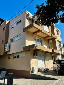 a building with a car parked in front of it at Juliya Apartment in Kavadarci