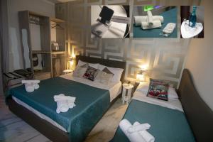 una camera da letto con due letti con asciugamani sopra di B&B Piccolo Lucio a Napoli
