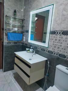 Appartement de luxe à 7 min de Centre de ville في مراكش: حمام مع حوض ومرآة